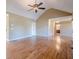 Bright living room with vaulted ceilings, hardwood floors, and open doorway to a full bath at 6365 Mountain View Trl, Cumming, GA 30041