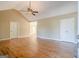 Open living room features vaulted ceilings, hardwood floors, and doorways to other rooms at 6365 Mountain View Trl, Cumming, GA 30041