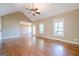 Spacious living room with hardwood floors, natural light, and a ceiling fan with lights at 6365 Mountain View Trl, Cumming, GA 30041