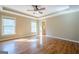 Main bedroom with hardwood floors, windows, and a tray ceiling with a ceiling fan at 6365 Mountain View Trl, Cumming, GA 30041