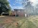 Large backyard showing deck and rear of house with brick and white siding at 9184 Thrash Sw St, Covington, GA 30014