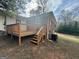 A spacious backyard with a wooden deck, perfect for outdoor relaxation and entertaining at 9184 Thrash Sw St, Covington, GA 30014