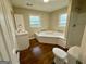 Bathroom area with a whirlpool tub and wooden floors at 9184 Thrash Sw St, Covington, GA 30014