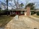 Lovely exterior of brick home featuring a chimney and front yard at 9184 Thrash Sw St, Covington, GA 30014