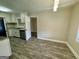 Kitchen area featuring white cabinets and stainless steel appliances at 9184 Thrash Sw St, Covington, GA 30014