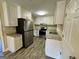 Kitchen area with granite countertops, modern appliances, and white cabinets at 9184 Thrash Sw St, Covington, GA 30014