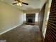 Spacious living room with fireplace and carpeted floors at 9184 Thrash Sw St, Covington, GA 30014