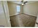Spacious bedroom featuring plush carpet, ceiling fan and a window offering natural light at 2232 Ramblewood Ne Cir, Decatur, GA 30035