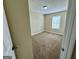 A neutral-toned bedroom with carpeted floors and a window allowing natural light at 2232 Ramblewood Ne Cir, Decatur, GA 30035