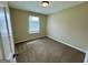 Cozy bedroom featuring plush carpet and a window offering natural light at 2232 Ramblewood Ne Cir, Decatur, GA 30035
