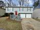 Charming home featuring a two-car garage, gray siding, and well-maintained landscaping at 2232 Ramblewood Ne Cir, Decatur, GA 30035