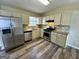 Modern kitchen with stainless steel appliances, granite countertops, stylish backsplash, and hardwood floors at 2232 Ramblewood Ne Cir, Decatur, GA 30035