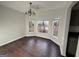 Open dining room with dark floors, chandelier and large bay windows at 3789 Conley Downs Ln, Decatur, GA 30034