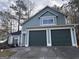 Charming home featuring an attached two-car garage and light-blue siding at 3789 Conley Downs Ln, Decatur, GA 30034