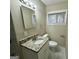 Bathroom featuring a granite vanity, updated fixtures, a toilet, and a window at 4352 Glenwood Pkwy, Decatur, GA 30032