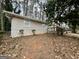 A single-story brick home with a deck, surrounded by mature trees and lush landscaping at 4352 Glenwood Pkwy, Decatur, GA 30032