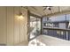 A covered balcony features neutral exterior, tile flooring, a light fixture, and a black metal railing at 3099 Balearic Se Dr, Marietta, GA 30067