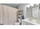 Bathroom featuring tile, a shower-tub, vanity and a shelf at 3099 Balearic Se Dr, Marietta, GA 30067