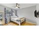Cozy bedroom featuring hardwood floors, fan and window with blue curtains at 3099 Balearic Se Dr, Marietta, GA 30067