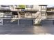 View of condos with garages and wooden balconies, set on a paved street with blue skies above at 3099 Balearic Se Dr, Marietta, GA 30067