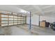 Spacious garage area, featuring lots of open space, with a rolling garage door, and cinder block walls at 3099 Balearic Se Dr, Marietta, GA 30067