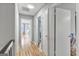 Hallway with hardwood floors and multiple doors leading to different rooms at 3099 Balearic Se Dr, Marietta, GA 30067
