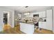 Modern kitchen with white cabinets, granite countertops, and stainless steel appliances at 3099 Balearic Se Dr, Marietta, GA 30067