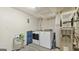 Bright laundry room featuring a modern washer and dryer, plus ample storage space on a storage rack at 3099 Balearic Se Dr, Marietta, GA 30067