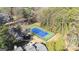 Aerial view of a community tennis court with blue surface and green border surrounded by trees at 3099 Balearic Se Dr, Marietta, GA 30067