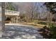 Spacious backyard with a deck, patio, and mature trees offering a private outdoor living space at 1615 Chattahoochee Run Dr, Suwanee, GA 30024