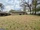 Backyard showcasing a grassy lawn, mature trees, and the home's exterior with windows at 1908 S Columbia Pl, Decatur, GA 30032