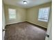Comfortable bedroom with plush carpeting, two sunny windows, and neutral paint at 1908 S Columbia Pl, Decatur, GA 30032