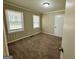 Cozy bedroom with plush carpeting, neutral decor, and two bright windows at 1908 S Columbia Pl, Decatur, GA 30032