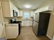 Updated kitchen showcasing stainless steel appliances, granite countertops, and ample cabinet space at 1908 S Columbia Pl, Decatur, GA 30032