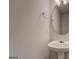 Bathroom featuring a pedestal sink, round mirror and classic lighting at 6380 Winston Trce, Mcdonough, GA 30252