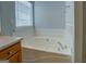Bathroom featuring a corner soaking tub with jets at 6380 Winston Trce, Mcdonough, GA 30252