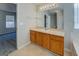 Bathroom with a large vanity, cabinets, and a view into an adjacent bedroom at 6380 Winston Trce, Mcdonough, GA 30252