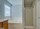 Well-maintained bathroom featuring a large soaking tub and a separate shower stall at 6380 Winston Trce, Mcdonough, GA 30252