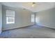 Large primary bedroom featuring plush carpeting, a ceiling fan, and bright, natural light at 6380 Winston Trce, Mcdonough, GA 30252