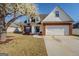 Charming home featuring a brick facade, two-car garage, flowering tree, and well-maintained lawn at 6380 Winston Trce, Mcdonough, GA 30252