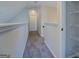 Bright hallway with carpet and white trim leading to a white interior door at 6380 Winston Trce, Mcdonough, GA 30252