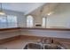 Bright kitchen showcasing vaulted ceilings and an inviting view into the adjacent living area with a fireplace at 6380 Winston Trce, Mcdonough, GA 30252