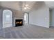 Open-concept living room with a fireplace and neutral carpet, creating a cozy and inviting space at 6380 Winston Trce, Mcdonough, GA 30252