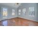 Sunlit living room with hardwood floors, vaulted ceilings, and a glass door leading to the backyard at 6380 Winston Trce, Mcdonough, GA 30252