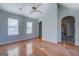 Spacious living room featuring arched doorways, hardwood floors, and plenty of natural light at 6380 Winston Trce, Mcdonough, GA 30252