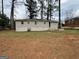 The backyard has a large grassy area, mature trees, and view of the home's exterior at 2194 Loring Ct, Decatur, GA 30032