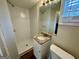 Well-lit bathroom features a shower, vanity with granite top, mirror, and window for natural light at 2194 Loring Ct, Decatur, GA 30032