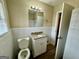 Well-lit bathroom featuring granite countertop, white cabinets, and classic fixtures at 2194 Loring Ct, Decatur, GA 30032