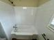 Bright bathroom featuring a white tiled bathtub and shower at 2194 Loring Ct, Decatur, GA 30032