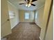 Inviting bedroom features a ceiling fan, neutral carpet, and natural light from the window at 2194 Loring Ct, Decatur, GA 30032